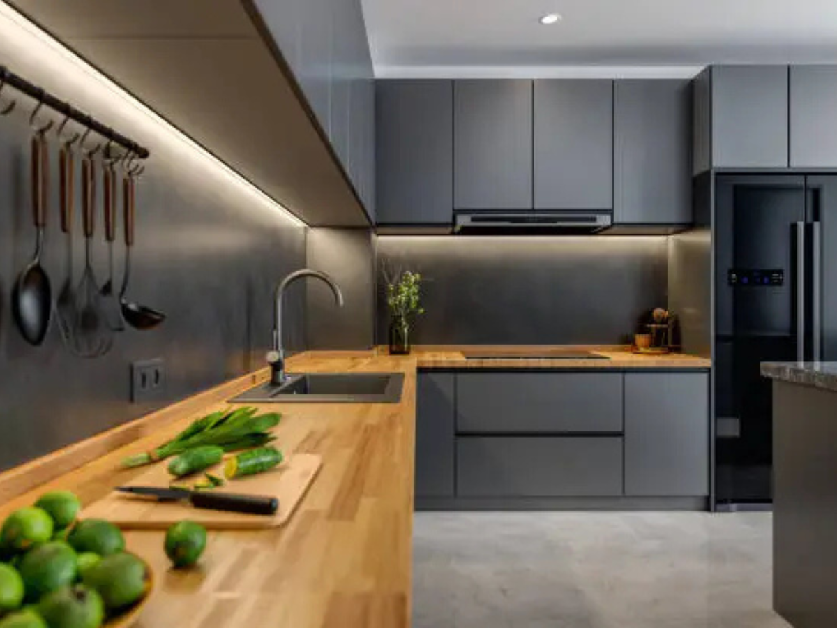 Dark grey modular kitchen with wooden countertop by Splendid Interio