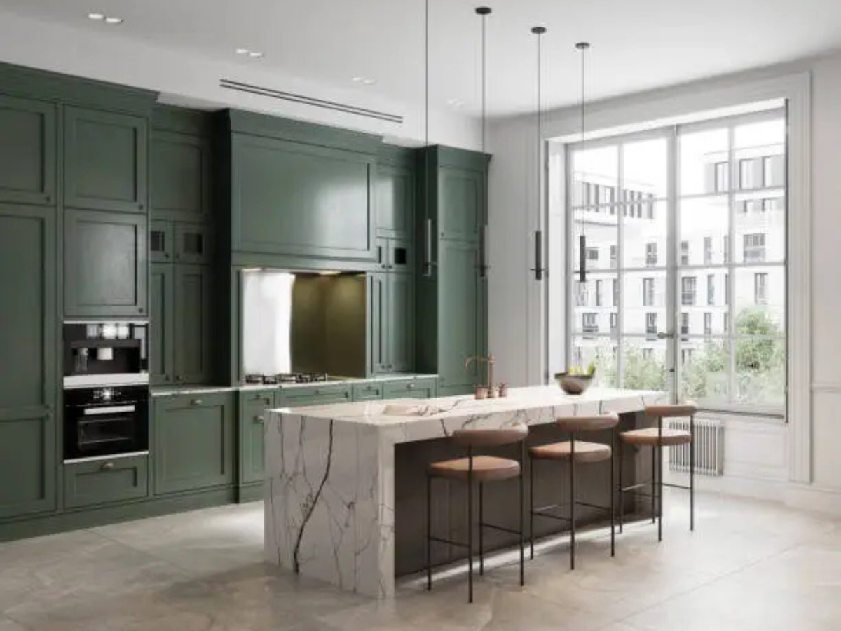 Sage green modular kitchen with marble island and bar seating by Splendid Interio